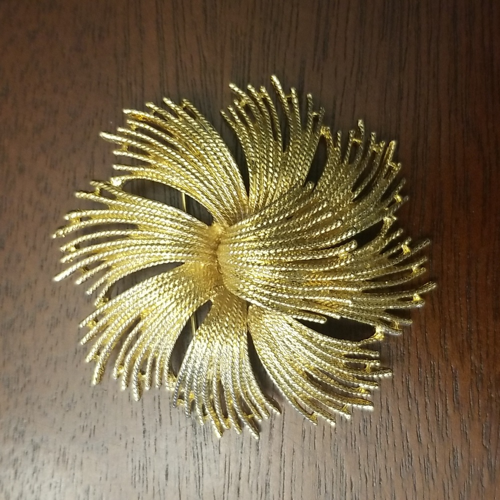 Vintage Monet gold tone brooch/pin.  Very nice condition. Stamped on back.